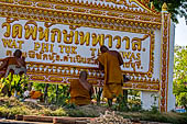 Buddhist monks painting along the canal leading to Damnoen Saduak Floating Market. 